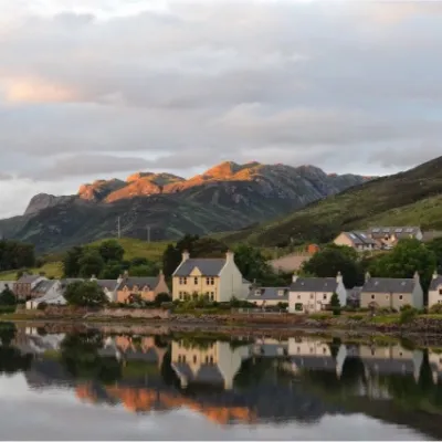 a large body of water with a mountain in the background