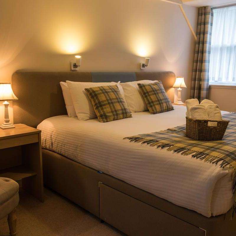 a bedroom with a large bed in a hotel room