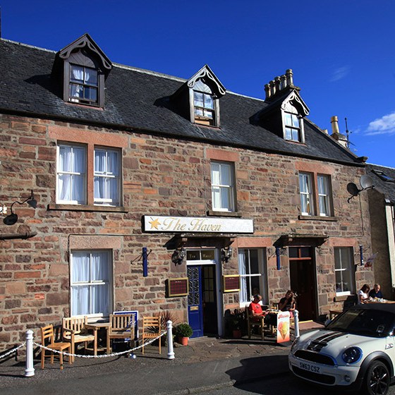 a car parked in front of a brick building