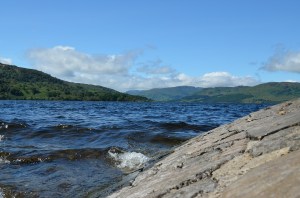 a body of water with a mountain in the background