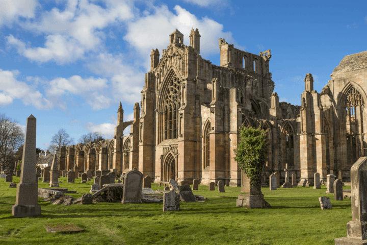 a large stone statue in front of a church