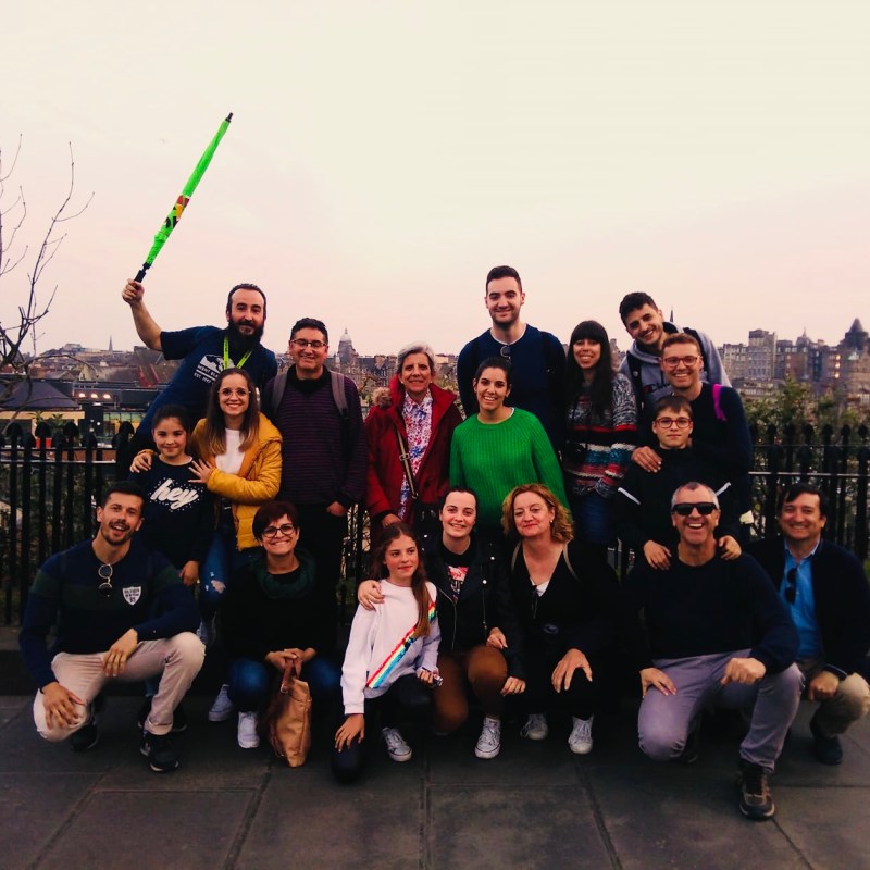 a group of people standing in front of a crowd posing for the camera