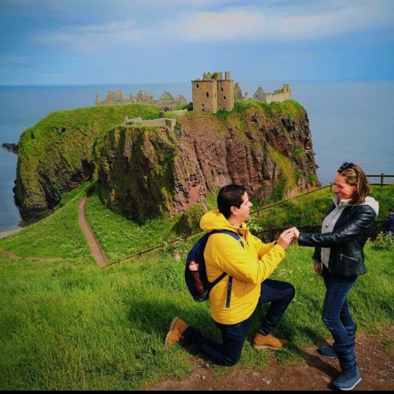 a group of people walking on a grassy hill
